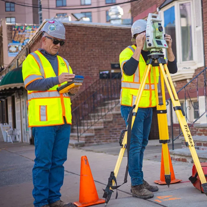 Control Point Associates surveyors working together on a field survey
